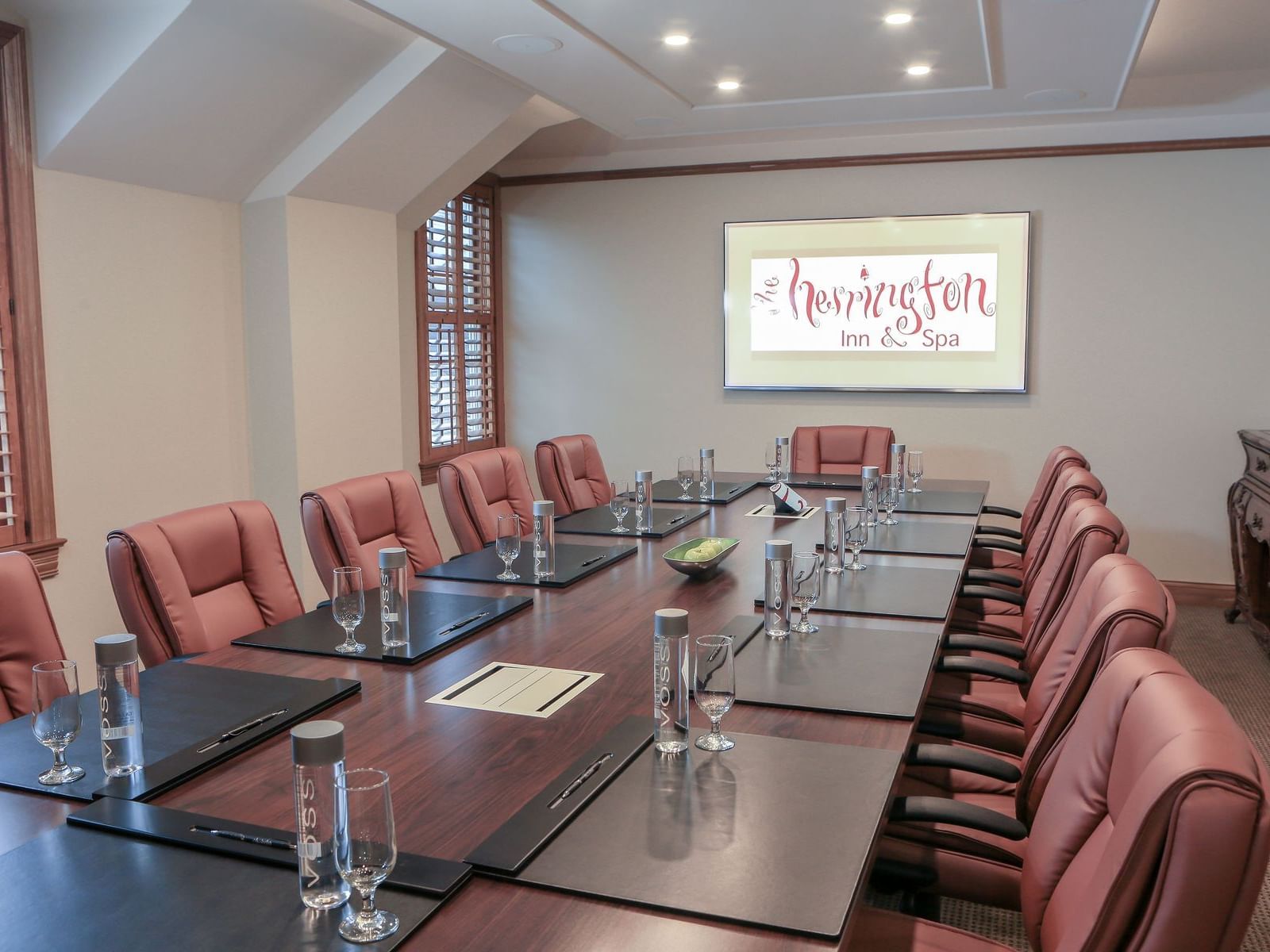 a large meeting desk and chairs