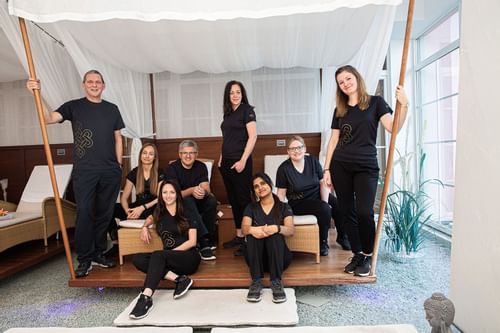 The team of Orjola Spa posing by a spa lounger at Liebes Rot
