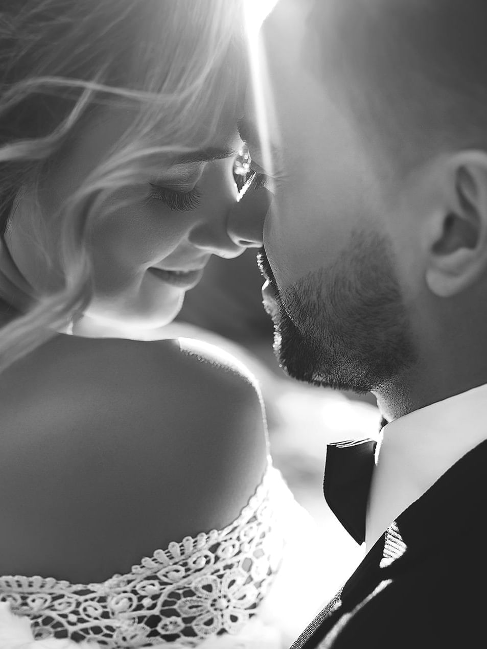 Black and white portrait of a bride with a groom in Crystal Hall at Naviti by Warwick Al Khobar