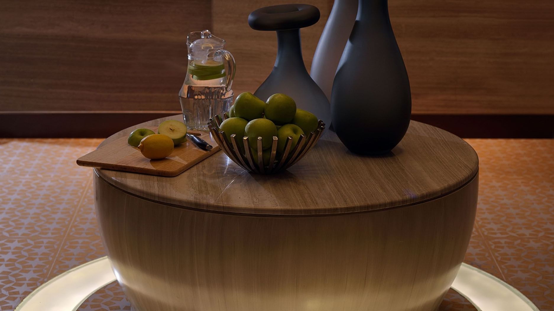 Coffee table featuring modern vases, a bucket of fruits & water at DAMAC Maison Cour Jardin