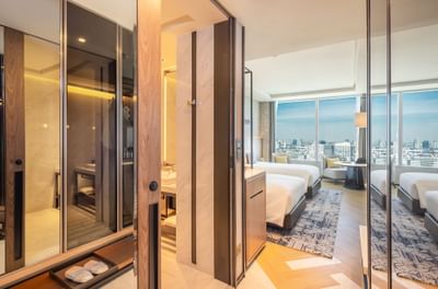 Two beds with city view in Superior Panorama room at Eastin Grand Hotel Phayathai