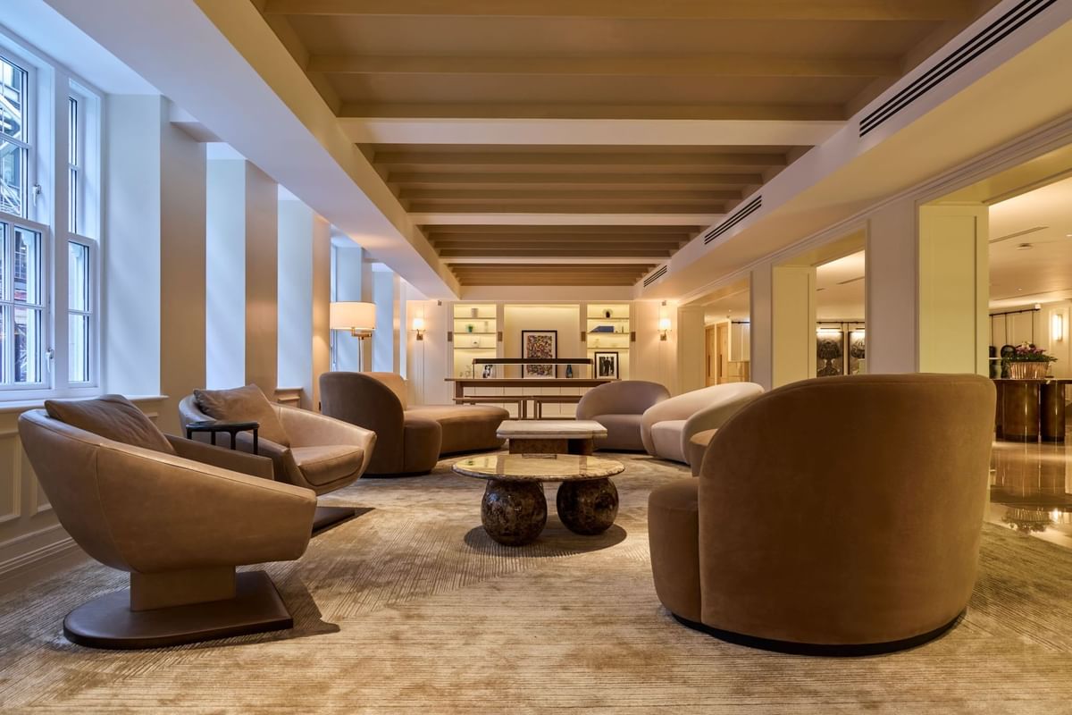  Lobby with elegant brown armchairs and sophisticated decor at The May Fair Hotel