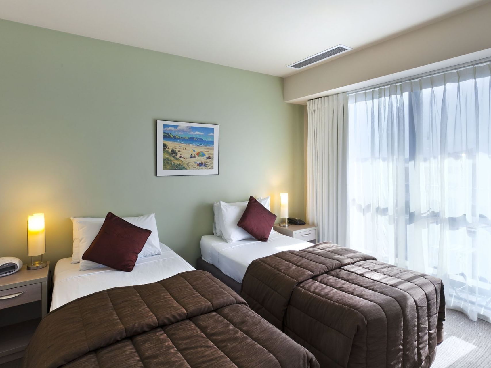 Single beds by the window in Studio Bedroom at Hotel Grand Chancellor