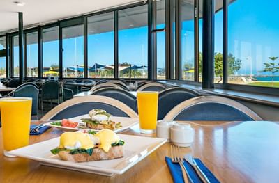 Benedicts served on a table with a view at Ocean Centre Hotel