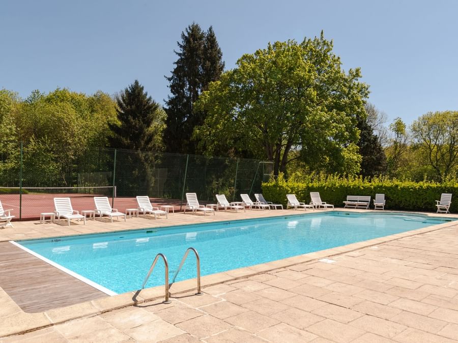 Outdoor swimming pool & sunbeds at Chateau du Landel Hotel