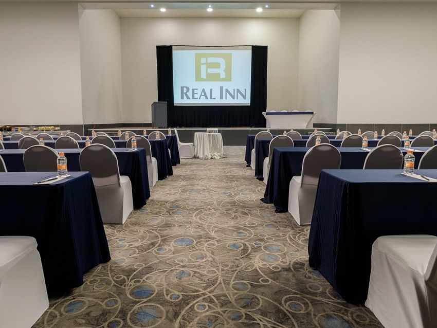 Large event room with tables and chairs set up at Real Inn Tijuana