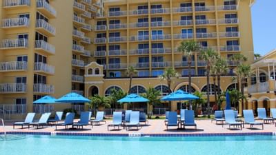 lounge chairs and umbrellas by the pool