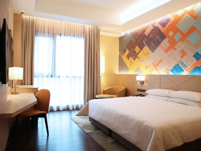 king bed, single sofa, and a TV in Premier King Room at Sunway Hotel Seberang Jaya