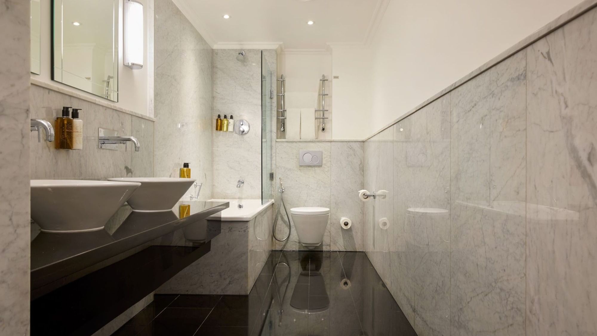 Bathroom with modern fixtures and a bathtub at The May Fair Hotel, London.