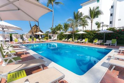 Sunlounger near square shape pool at Buenaventura Grand Hotel