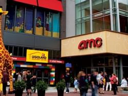 people walking in front of a movie theatre