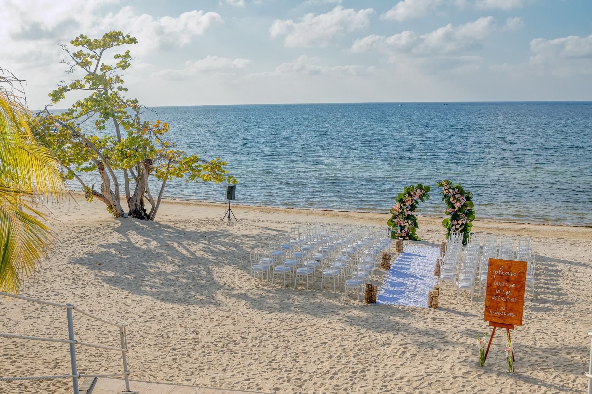 A previous beach ceremony at Las Verandas, with chairs and a floral arch overlooking the sea