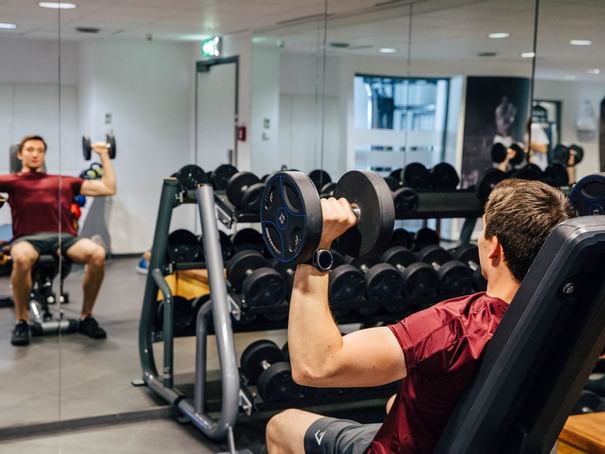 A man exercising in a fitness center at Hotel Berlin Berlin