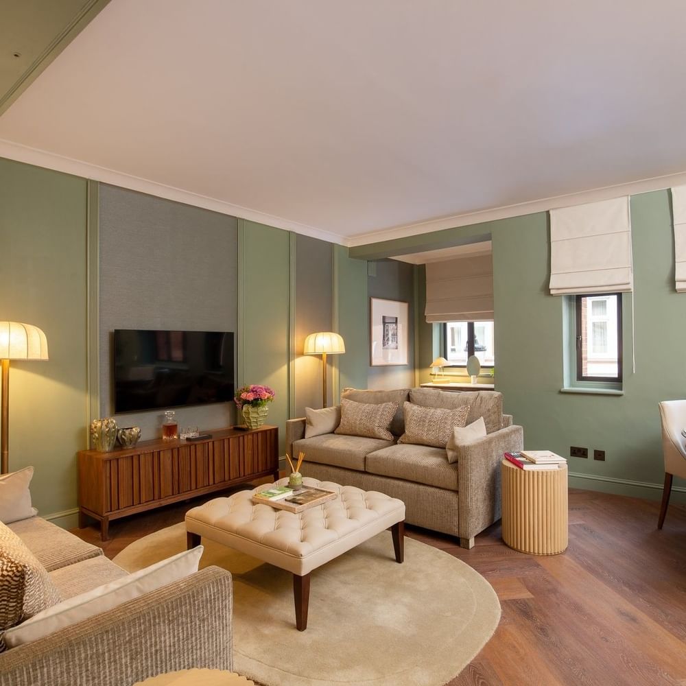 Two Bedroom Apartment TV lounge with plush sofas at The Capital Hotel, Apartments and Townhouse