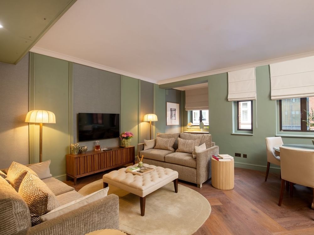 Two Bedroom Apartment TV lounge with plush sofas at The Capital Hotel, Apartments and Townhouse