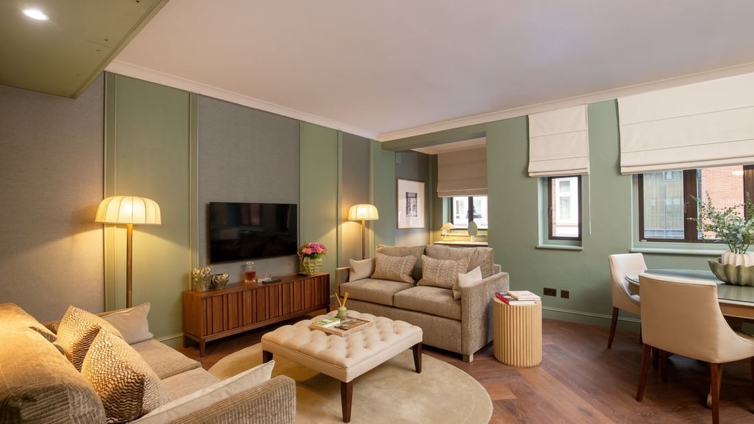 Two Bedroom Apartment TV lounge with plush sofas at The Capital Hotel, Apartments and Townhouse