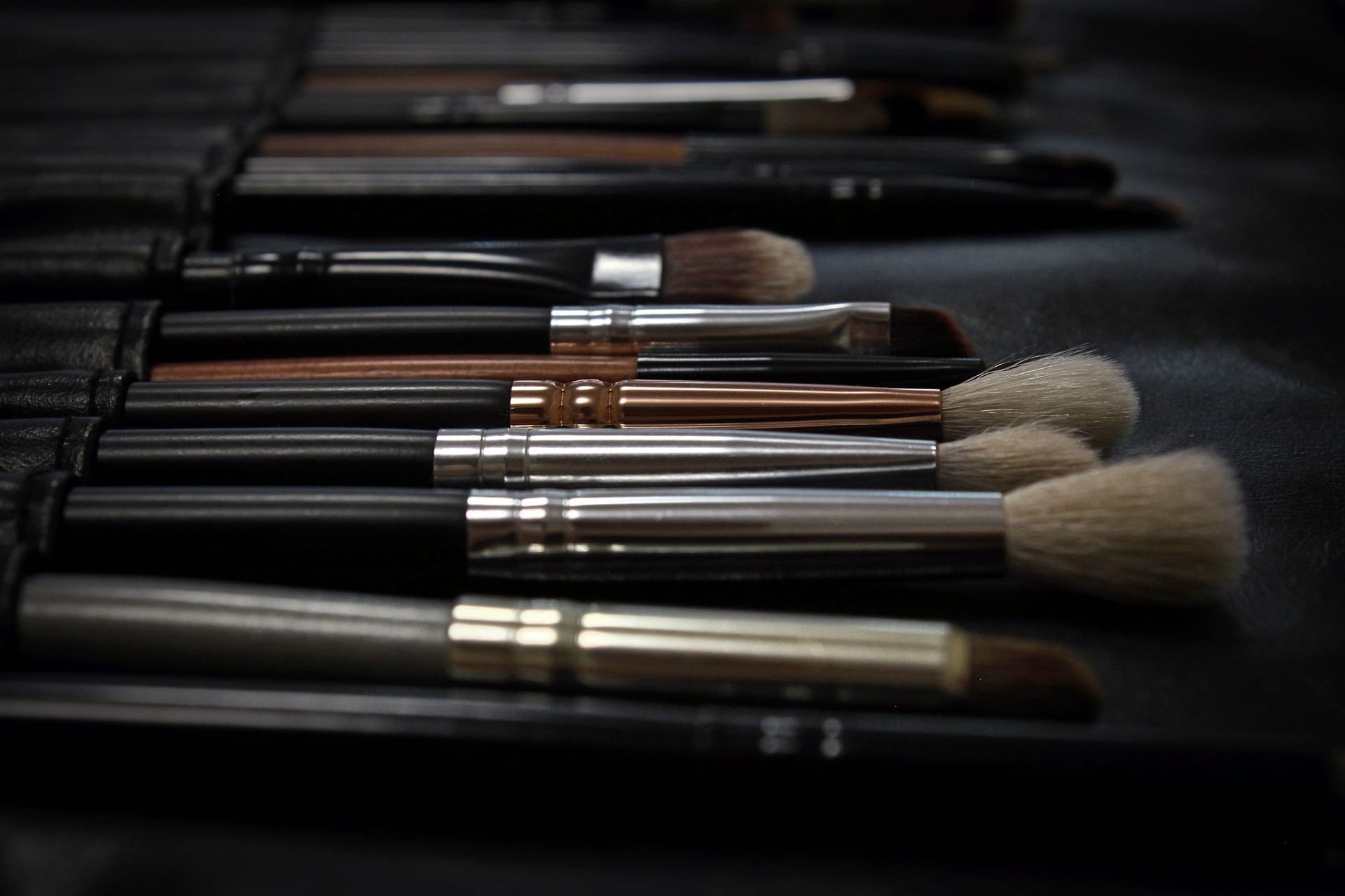 Make-up brushes and tools lined up on a table at Warwick Paris Champs Elysées