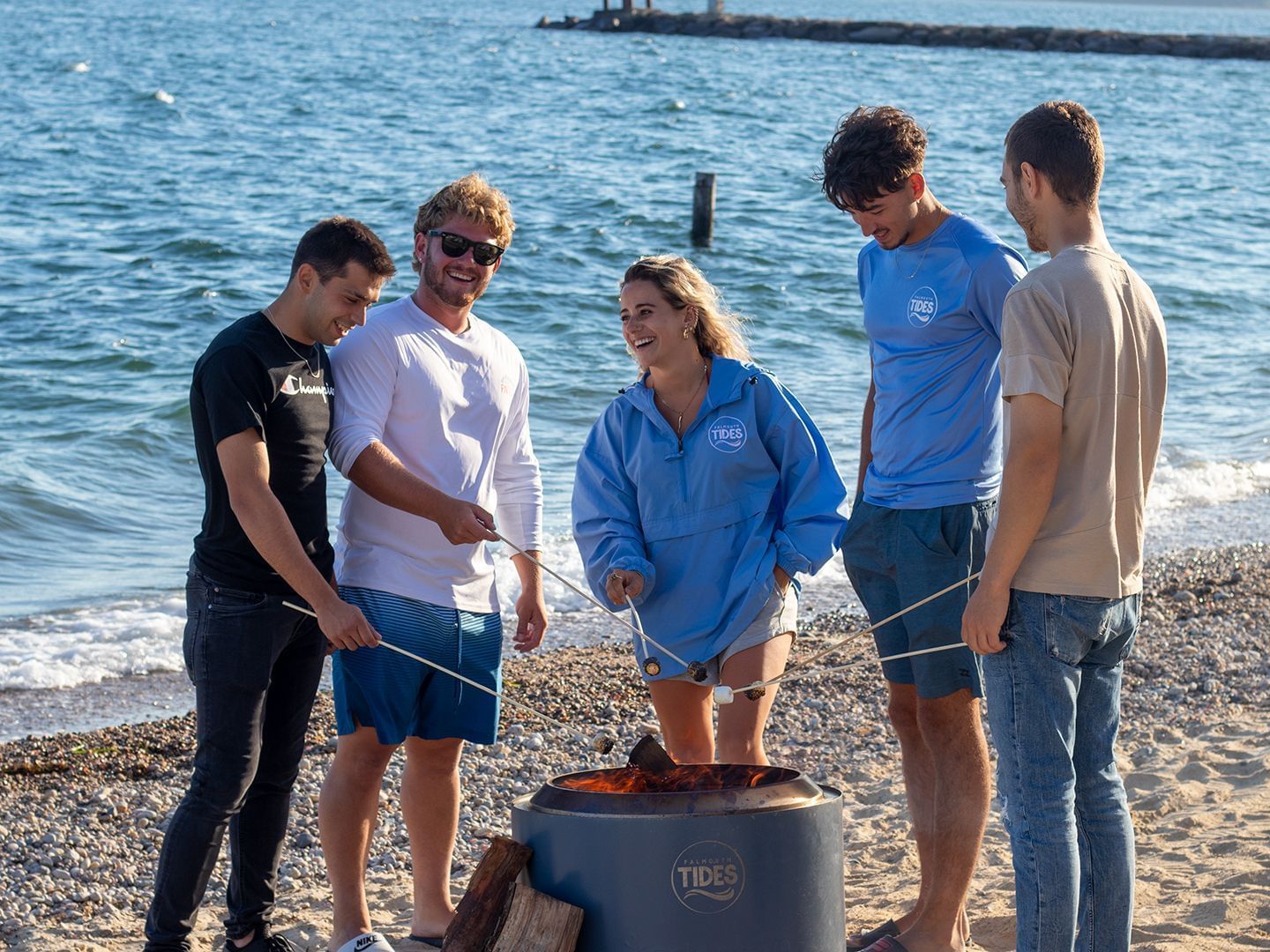 A group of friends BBQing by the beach near Falmouth Tides