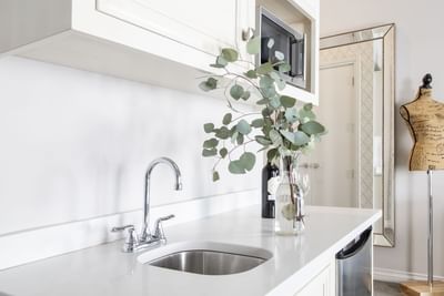 Kitchen countertop with faucet & wine bottle in King Premiere Paris at Retro Suites Hotel