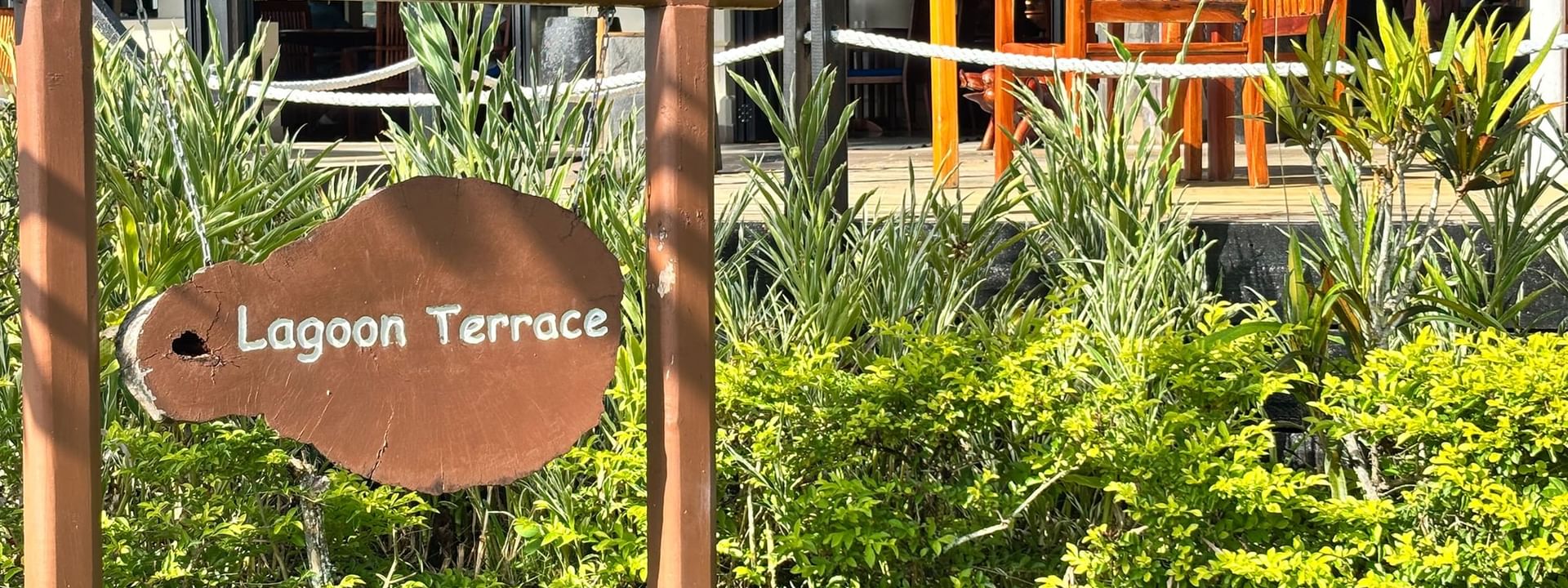 Wooden Lagoon Terrace sign by lush plants at Warwick Le Lagon - Vanuatu, Efate