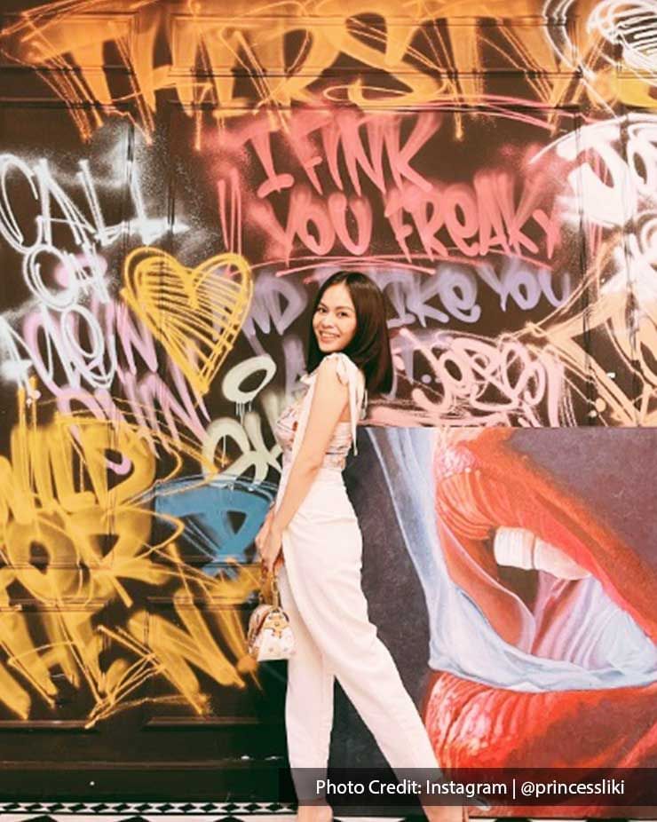 A woman was taking pictures with the wall art at Beso Rosado - Lexis Suites Penang