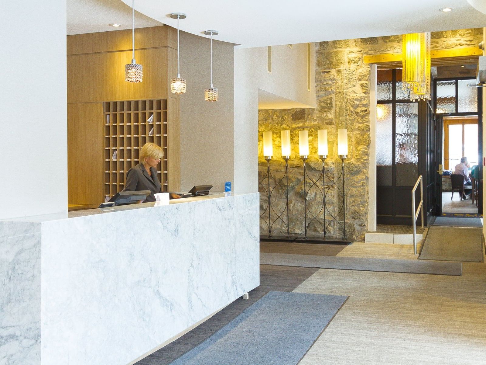 Front desk by lobby lounge area with carpeted floors at Hotel Port Royal