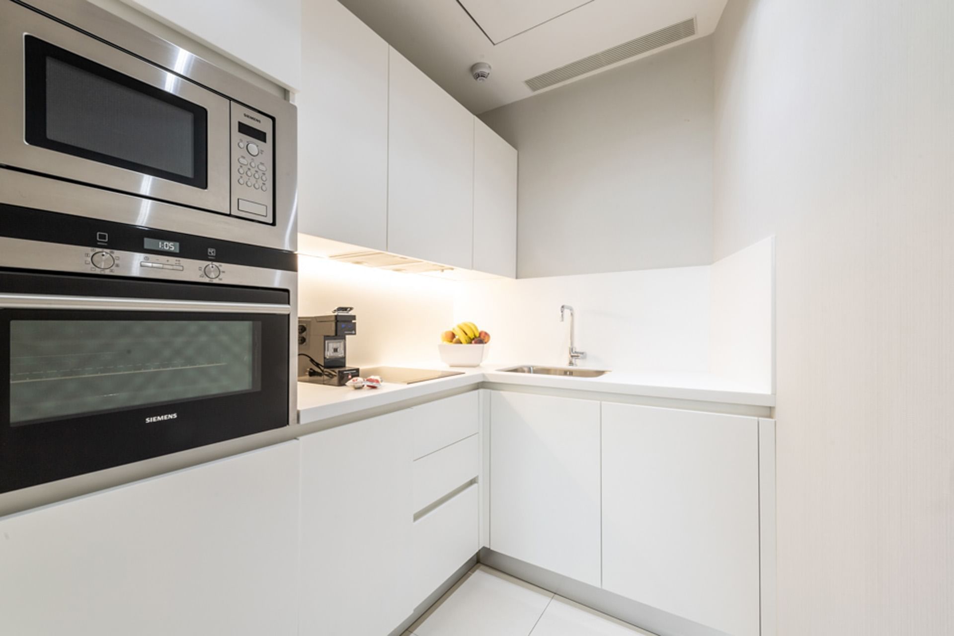 Suite con cucina moderna con elettrodomestici Siemens e frutta sul bancone a DUPARC Contemporary Suites