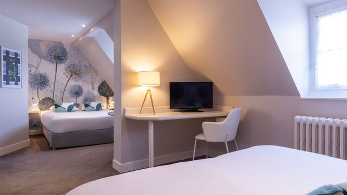 2-bedroom suite with a TV & work desk at The Originals Hotels