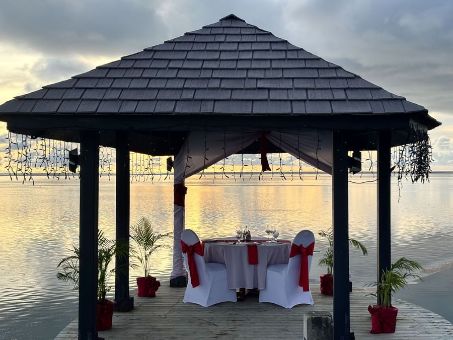 Romantic waterfront gazebo dining with sunset view at Warwick Fiji Resort and Spa.