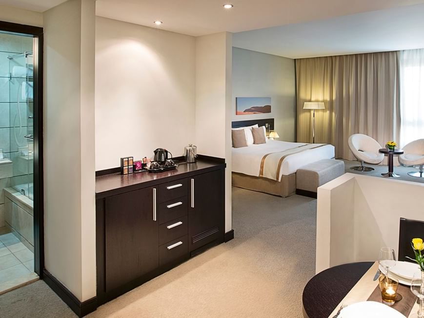 Bed & bathroom in Deluxe Room at City Seasons Hotels