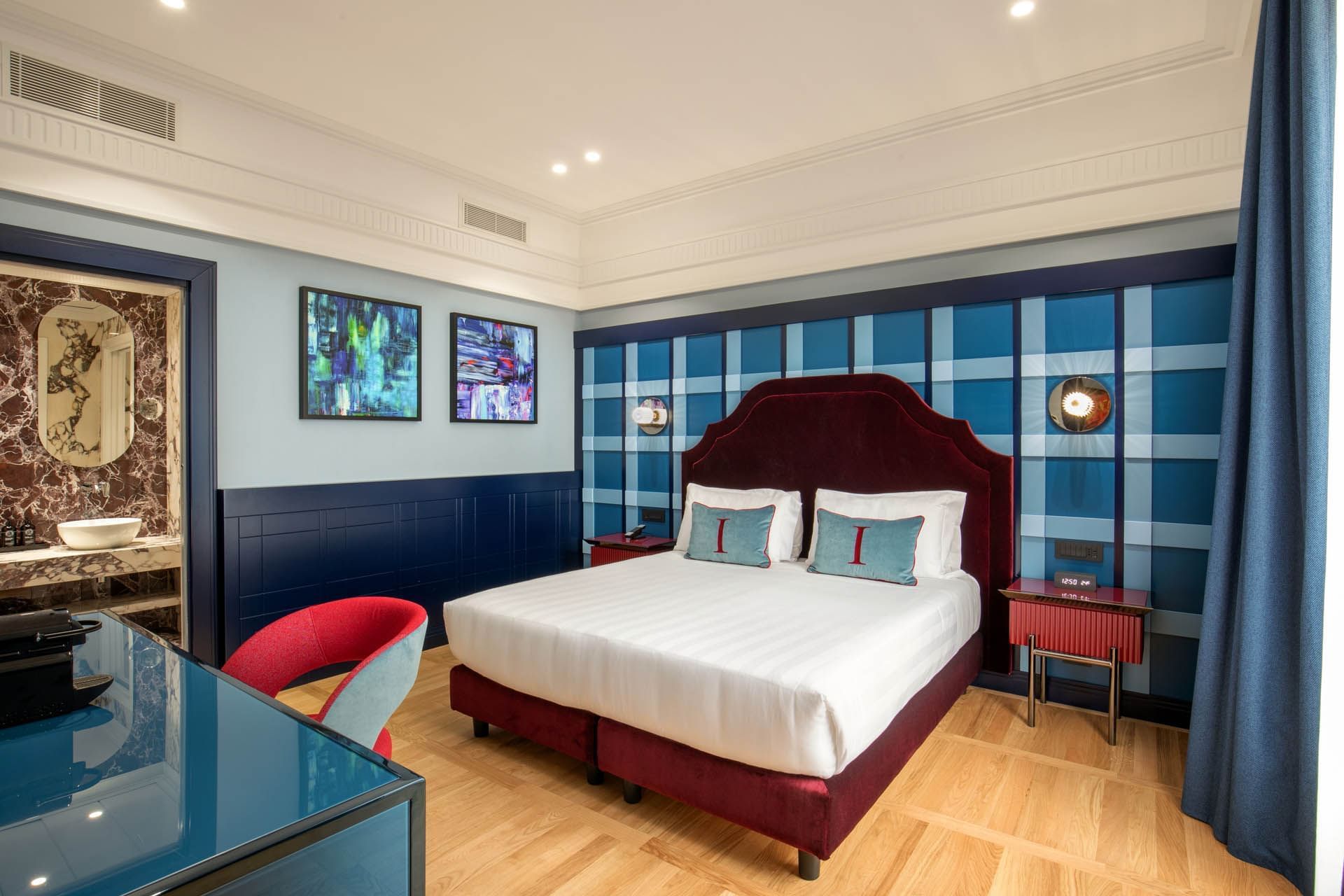 Modern Cielo Suite with stylish decor, smart bathroom entrance, and wooden floors at The Independent