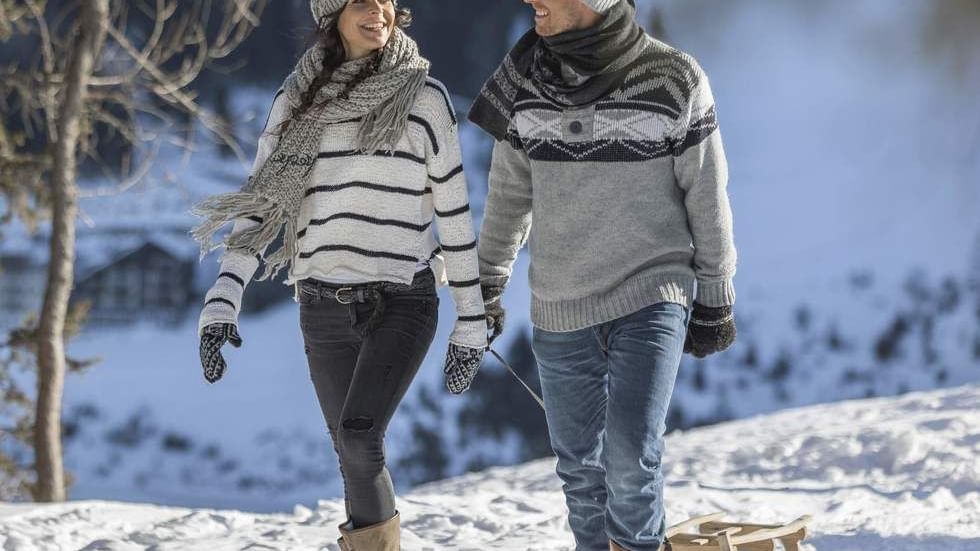 Couple getting ready for tobogganing near Falkensteiner Hotel Sonnenalpe