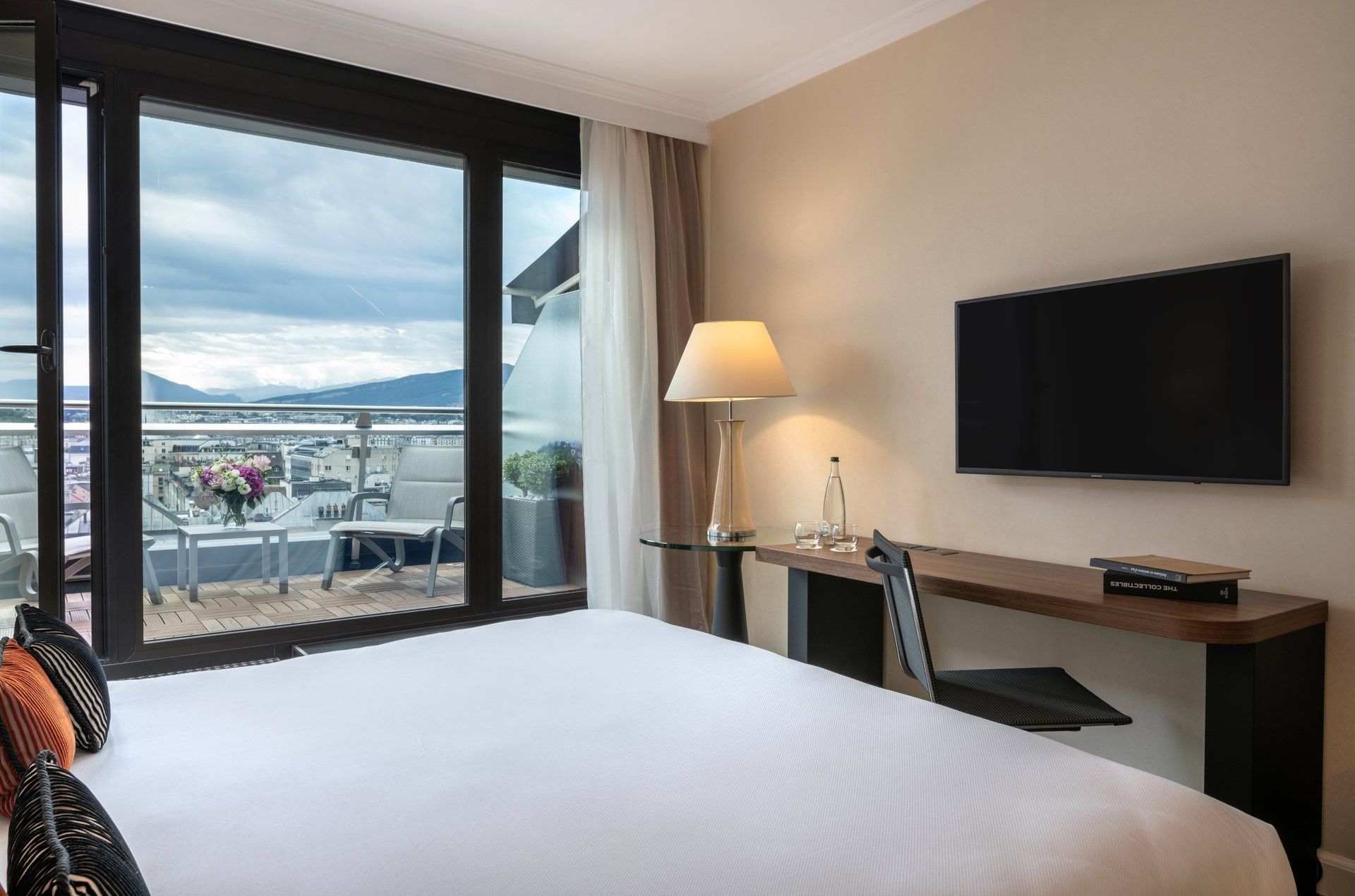 Penthouse Terrace Room featuring Sleek desk by a glass table under a lamp at Warwick Geneva