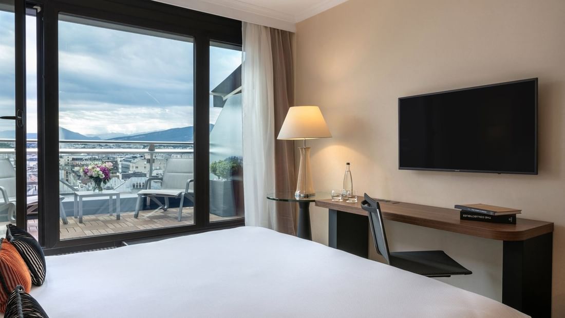 Penthouse Terrace Room featuring Sleek desk by a glass table under a lamp at Warwick Geneva