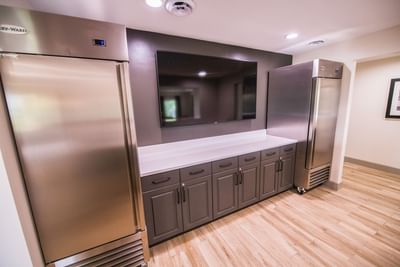 kitchen counter with two refrigerators and view of tv