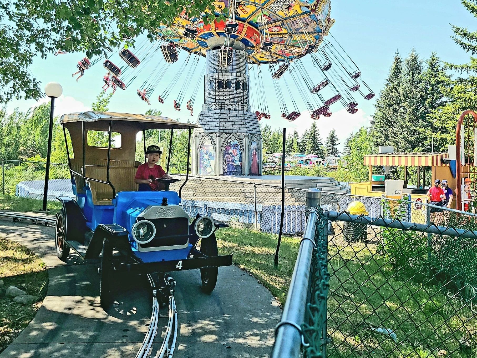 A kid playing with a car at Calaway Park near Hotel Clique Calgary Airport