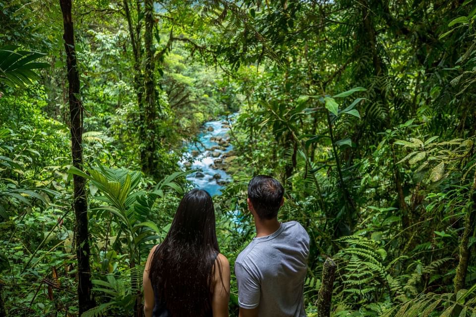 Couple overlooking the Celeste River near Hideaway Rio Celeste