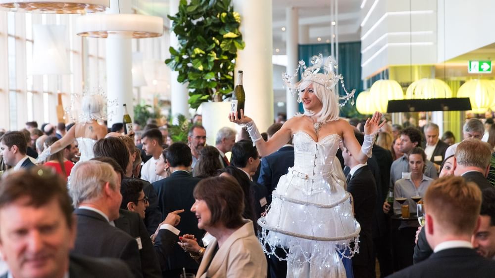 Event with woman in an illuminated costume serving drinks in The Ternary at Novotel Sydney on Darling Harbour