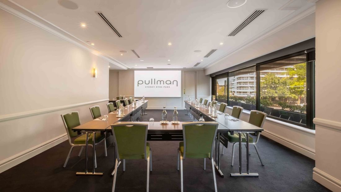 U-shape table set-up with projector screen in Parkview Room at Pullman Sydney Hyde Park