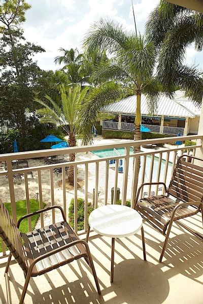 Balcony lounge area with a pool view at Trianon Bonita Bay