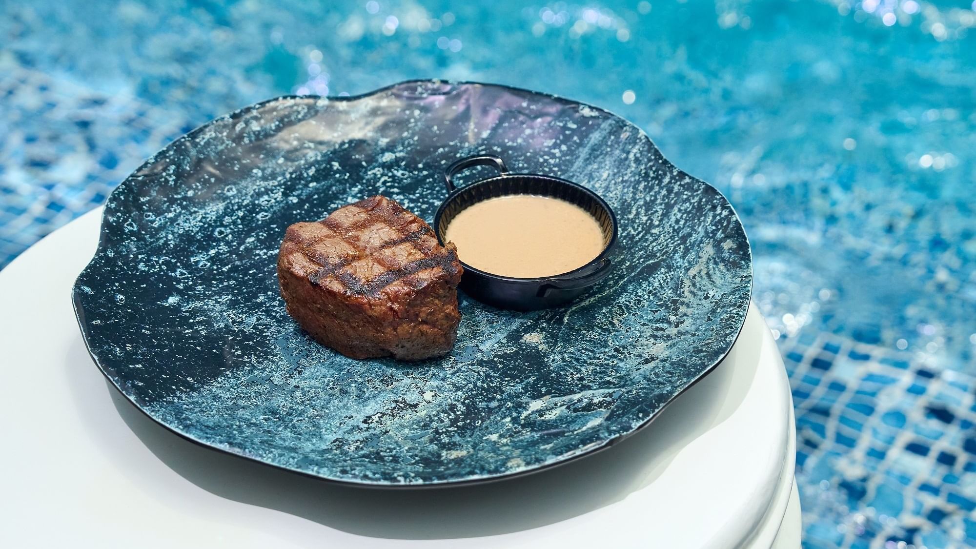 Fillet Steak served by the pool edge at Malibu Deck Pool bar in Paramount Hotel Dubai