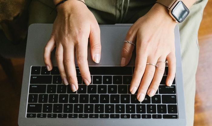 Close-up of a person working on the laptop at Anaheim Portofino Inn & Suites