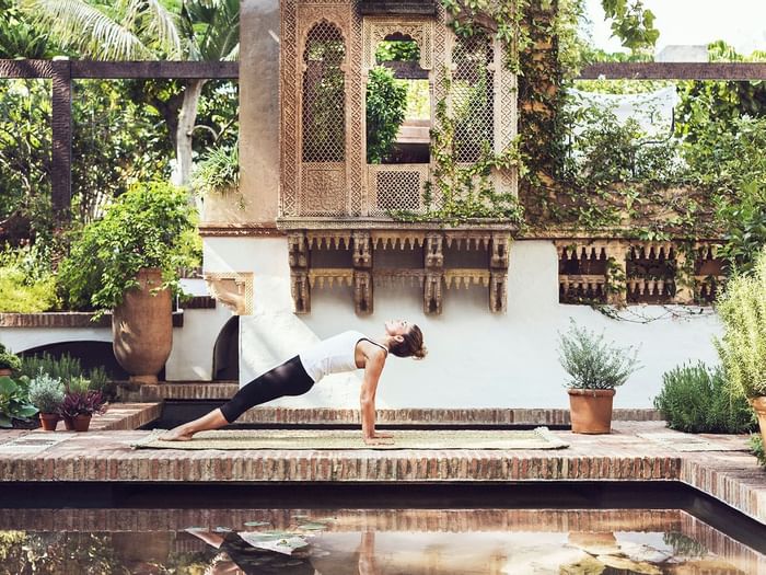 A woman practicing yoga at Marbella Club Hotel
