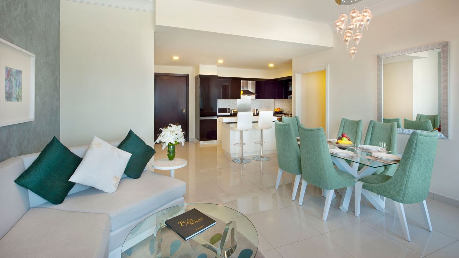 Living area, dining table and kitchen in Three Bedroom Suite at DAMAC Maison Dubai Mall Street