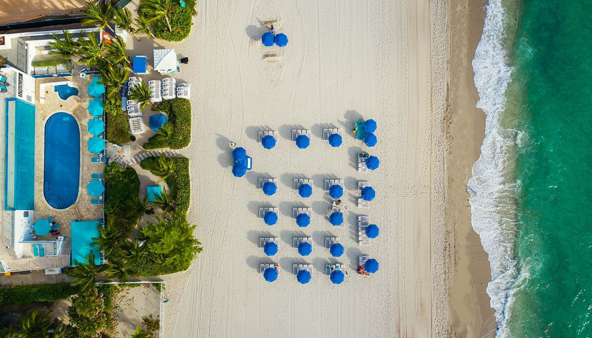 Outdoor pool, sun beds on the beach at Marenas Resort Miami
