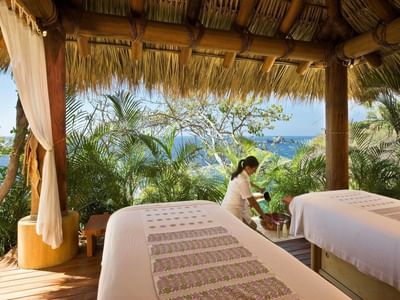 Spa attendant in the outdoor spa at Cala de Mar