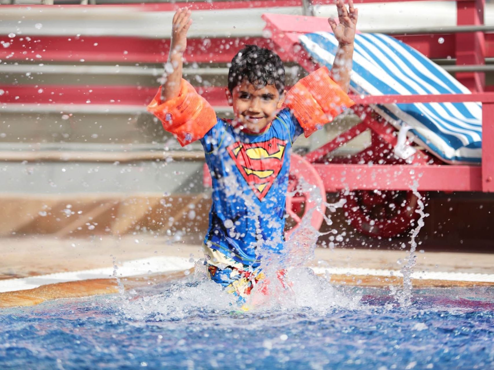 Child playing in the pool at Mena ApartHotel Albarsha Dubai