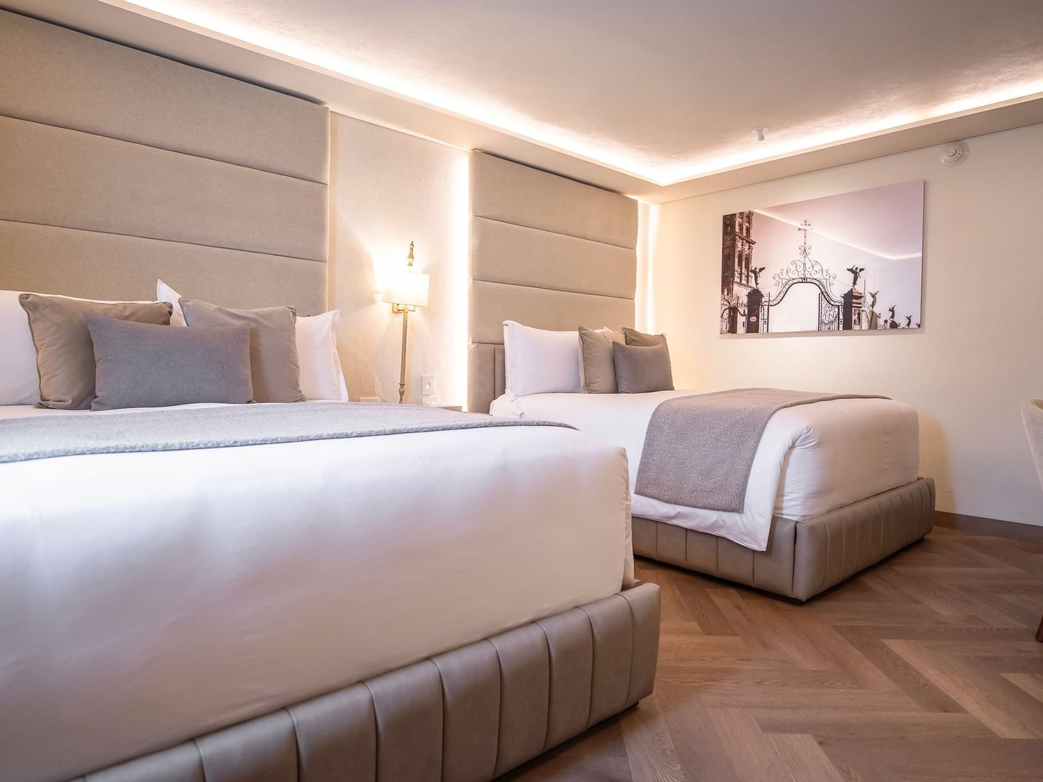 Two beds with white and gray bedding in a room at Quinta Real Puebla in Heroica Puebla de Zaragoza.