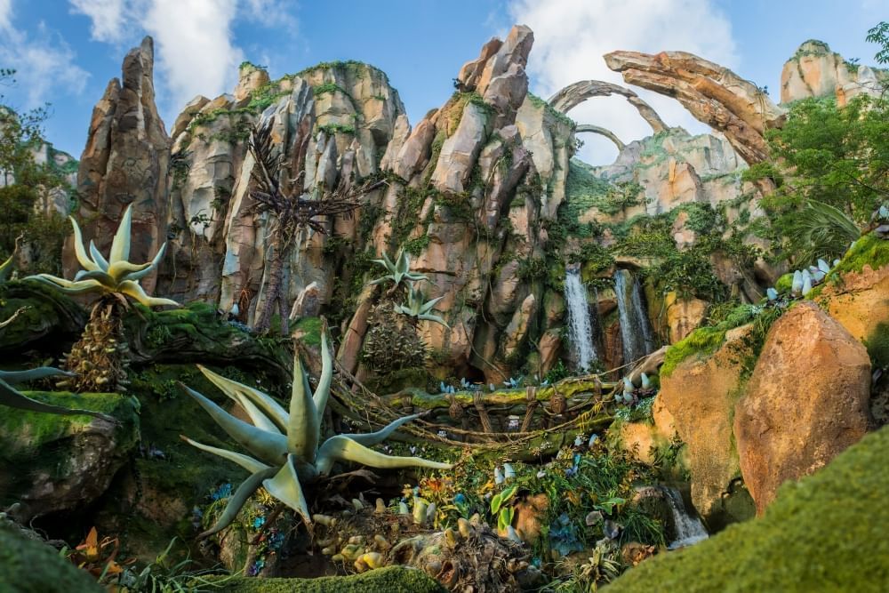 Tall, rocky walls, waterfalls, and aloe-like plants create a fantasy-inspired scene at Animal Kingdom’s Pandora, a beautiful place to enjoy a spring day at Animal Kingdom.