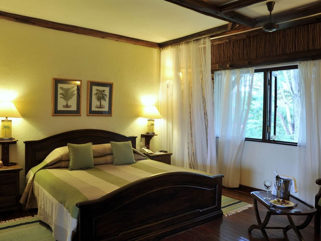 A Kings bed in Kilaguni Suite bedroom at Hotel Kilaguni Serena